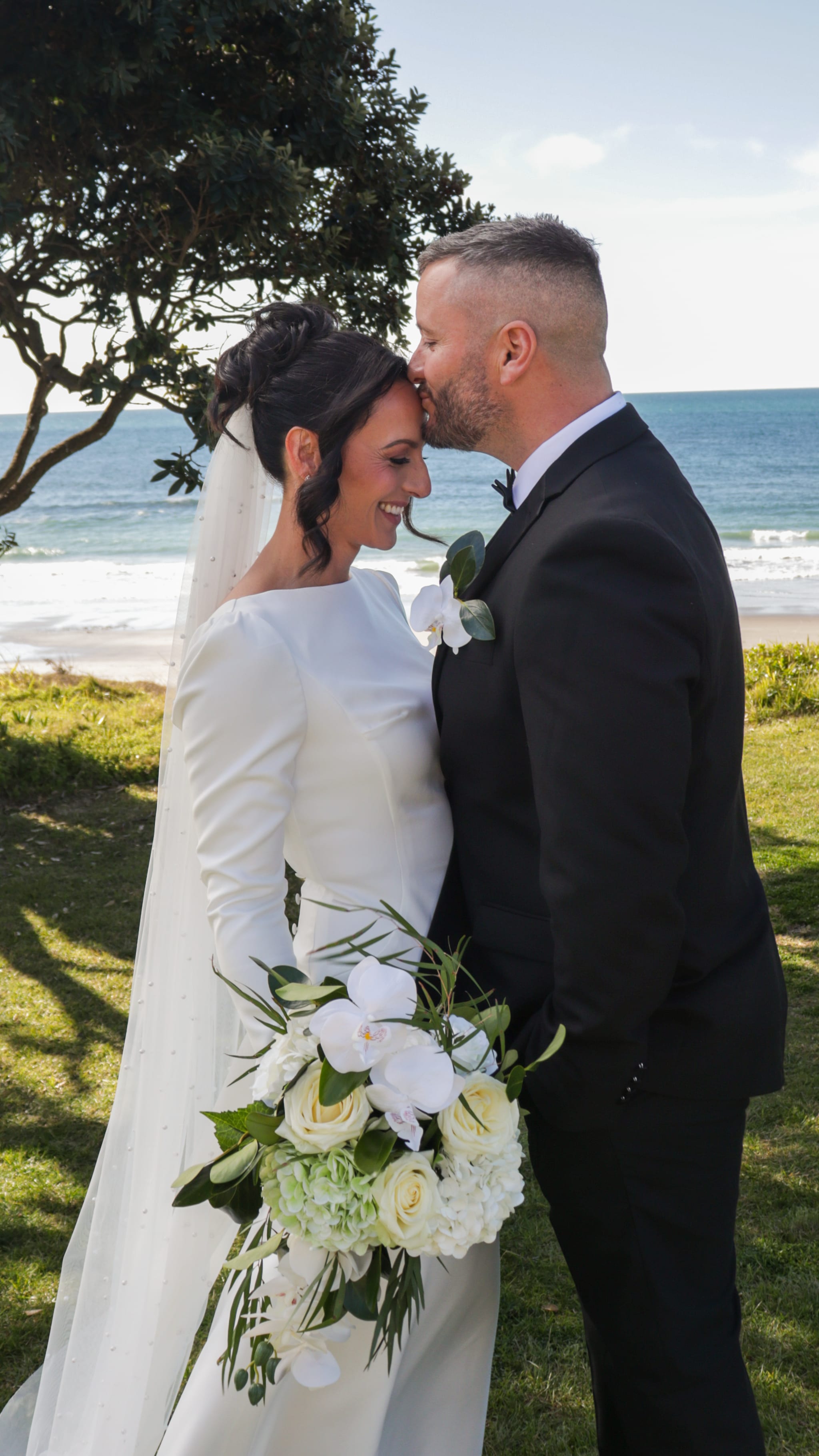 groom kissing bride forehead