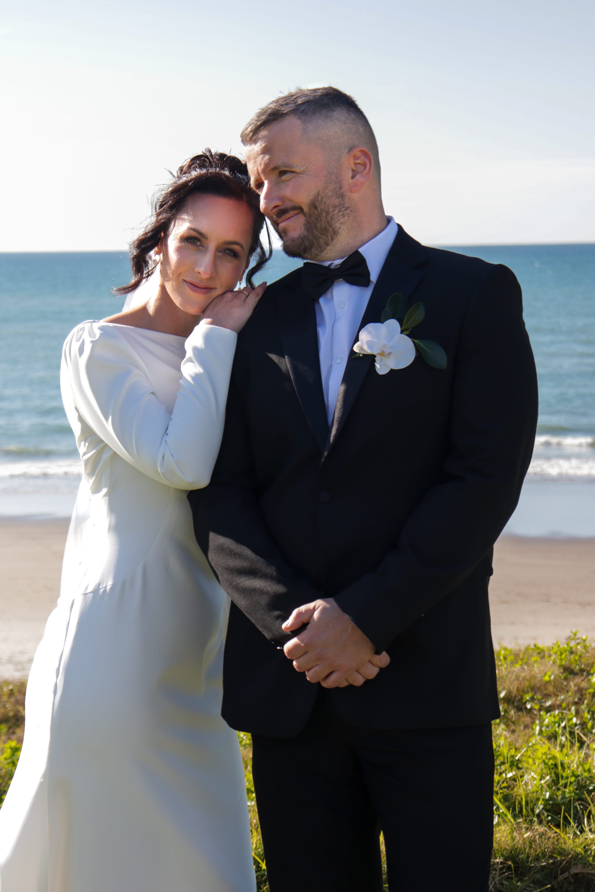 Bride leaning on grooms shoulder